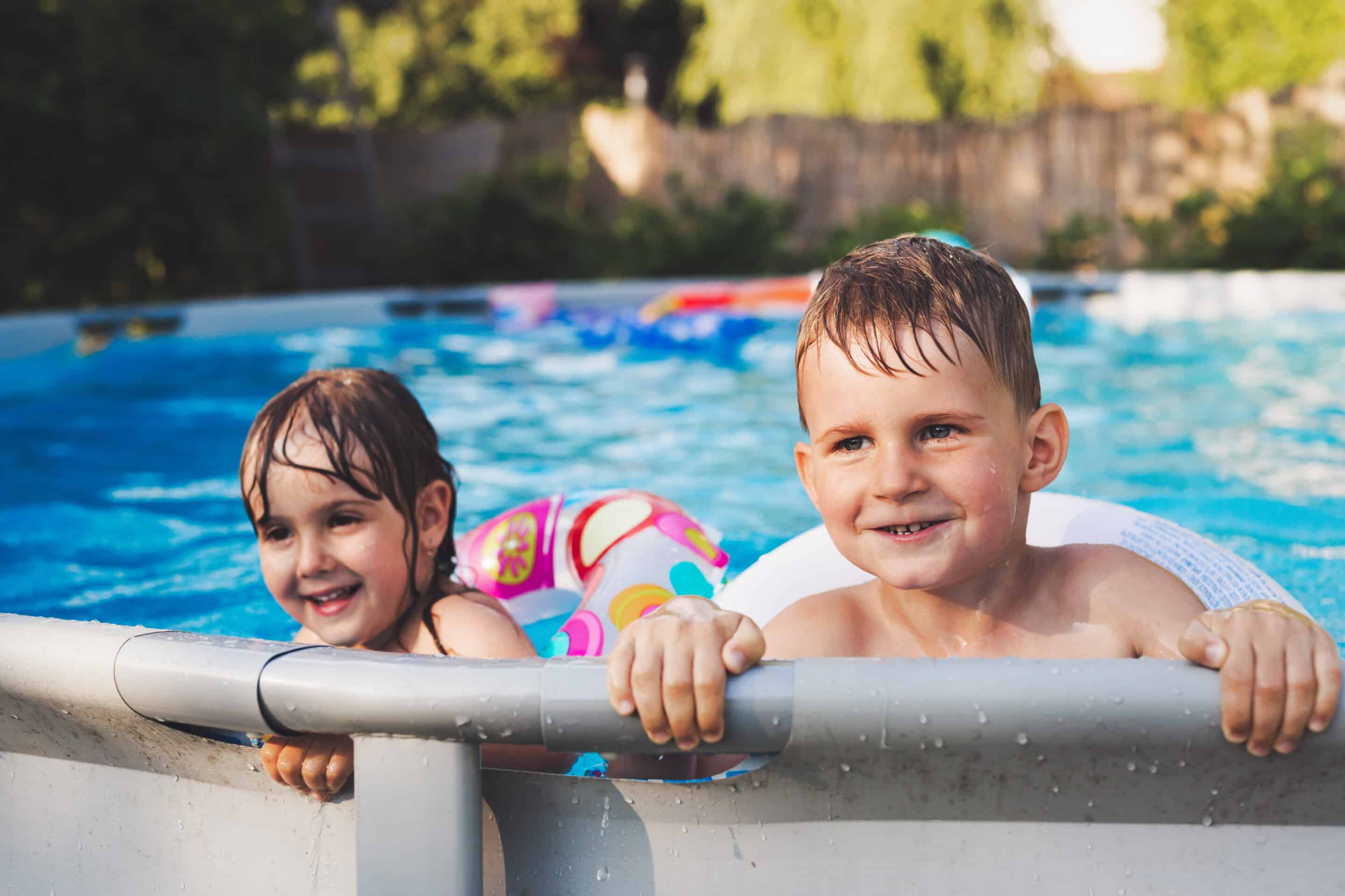 two little kids enjoying in swimming pool